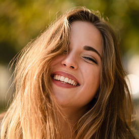 Closeup of woman smiling while enjoying the outdoors
